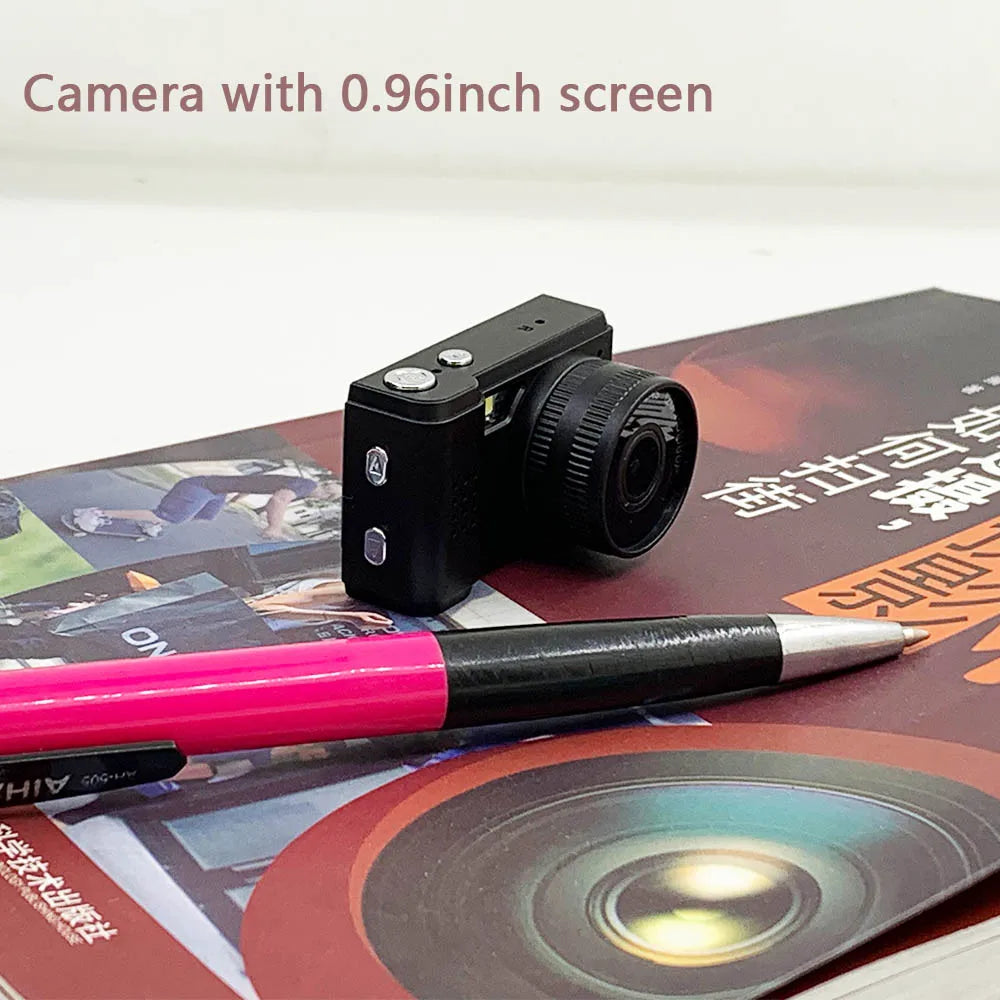 Mini camera with 0.96 inch screen next to a pen